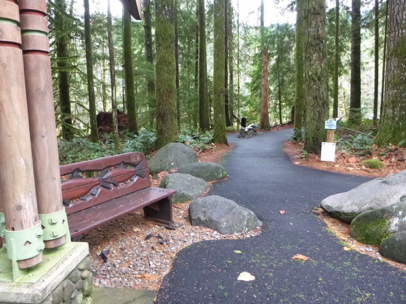 Start of the paved Streamwatch Trail – bench on loose gravel has a lip at transition – tactile art of salmon